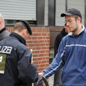 Sebastian Thom, NPD-Kreisverbandschef von Neukölln wird bei einer NPD Kundgebung 2011 in Berlin von der Polizei durchsucht.